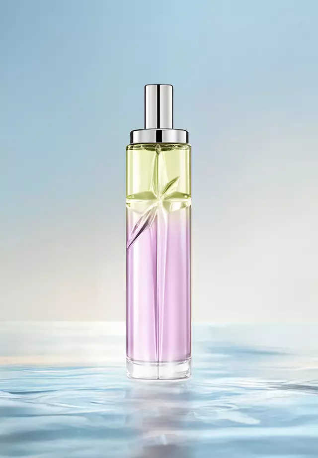 Gourmet Berry Starlicious-recept voor laagjes: hoge flacon met lichtgroen en roze kleurverloop op rimpelend water tegen een zachtblauwe achtergrond. Zure, zoete, sappige geur met zoete nootachtigheid; 3 sprays Berry Licorice, 1 Pistachio Praline.
